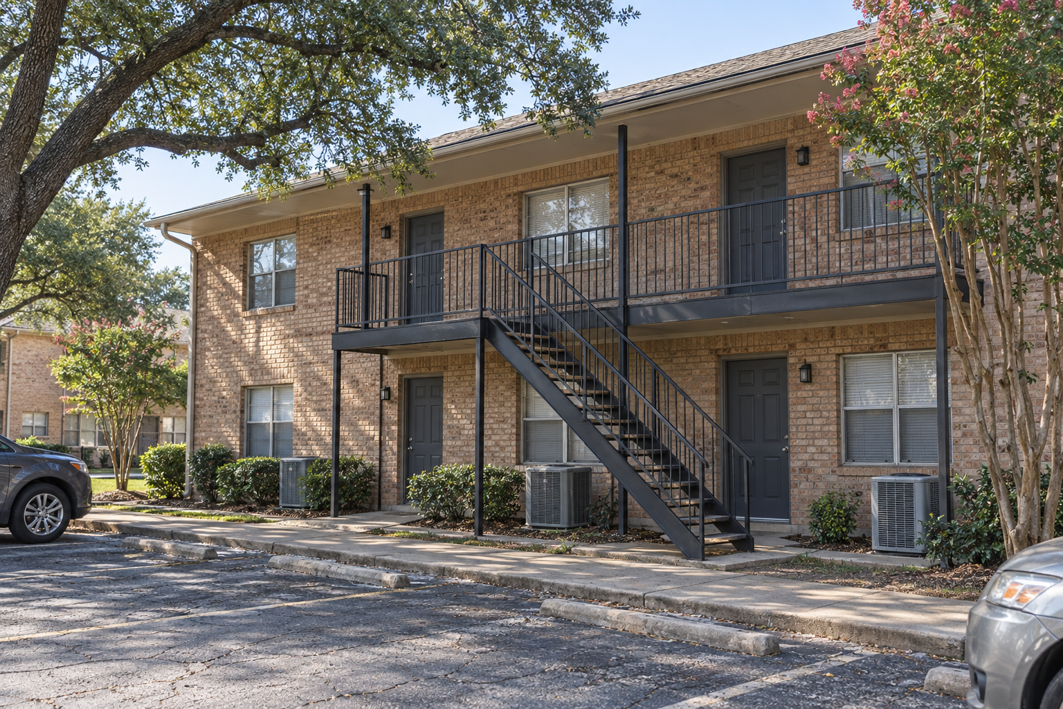 Low brick apartment block with exterior stairs in Richardson